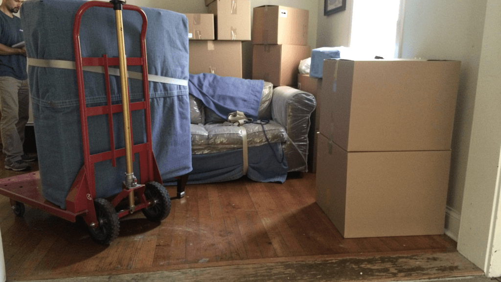 Moving boxes and wrapped furniture ready for pickup